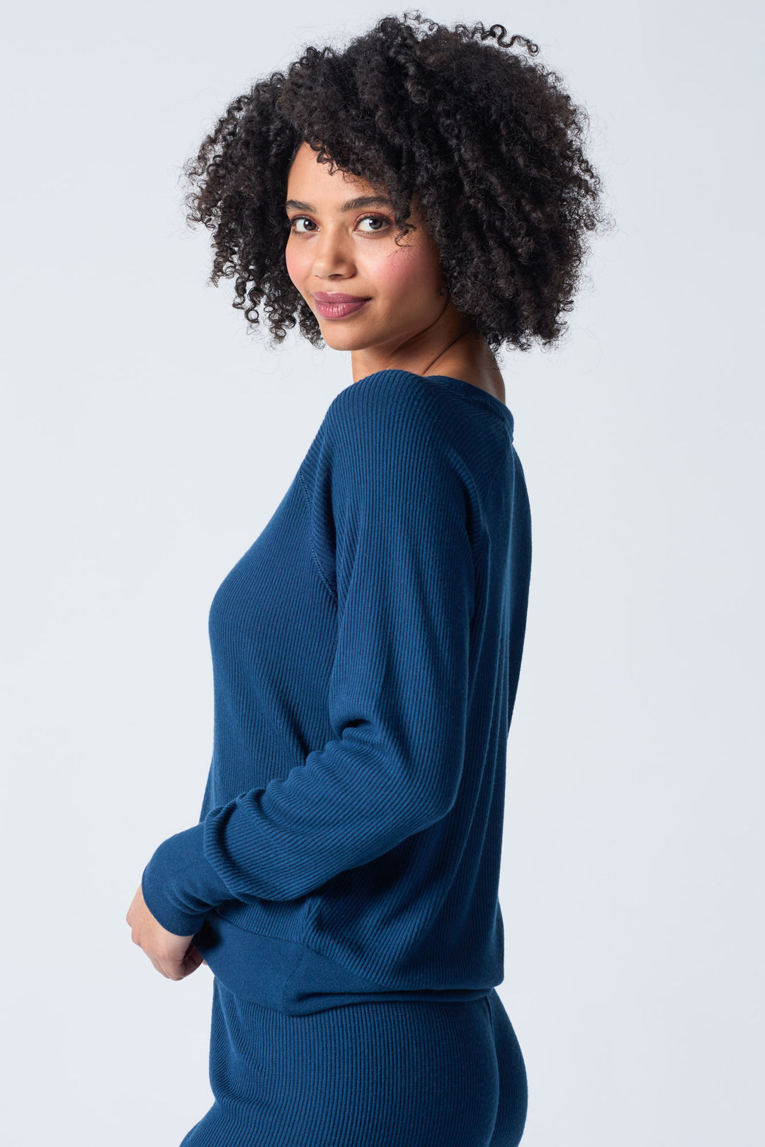 Navy V-neck top with relaxed fit in 2x2 peachy rib. Banded sleeve cuff & neck rib.