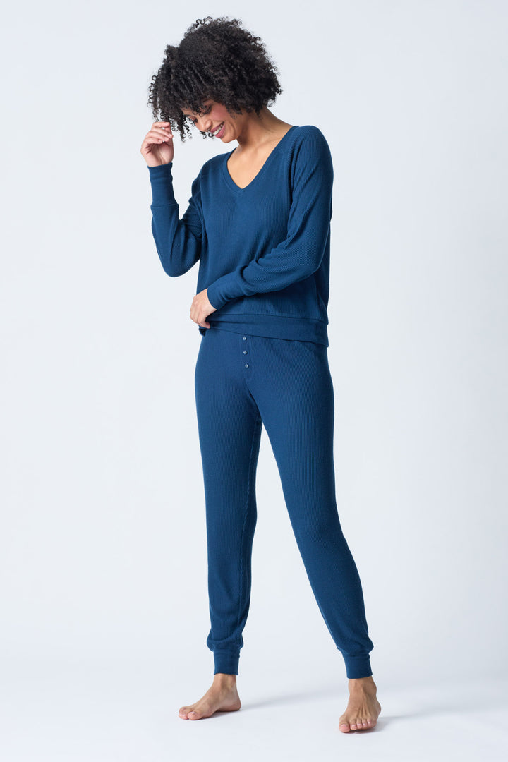 Navy V-neck top with relaxed fit in 2x2 peachy rib. Banded sleeve cuff & neck rib.