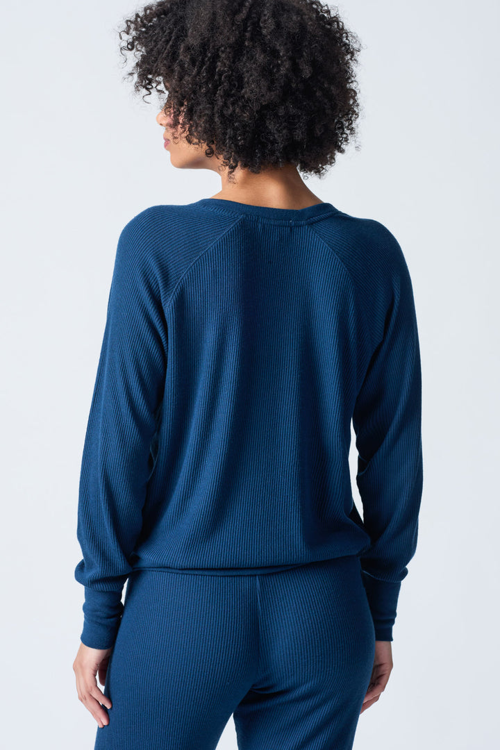 Navy V-neck top with relaxed fit in 2x2 peachy rib. Banded sleeve cuff & neck rib.