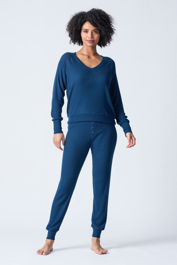 Navy V-neck top with relaxed fit in 2x2 peachy rib. Banded sleeve cuff & neck rib.