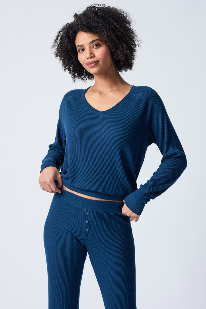 Navy V-neck top with relaxed fit in 2x2 peachy rib. Banded sleeve cuff & neck rib.