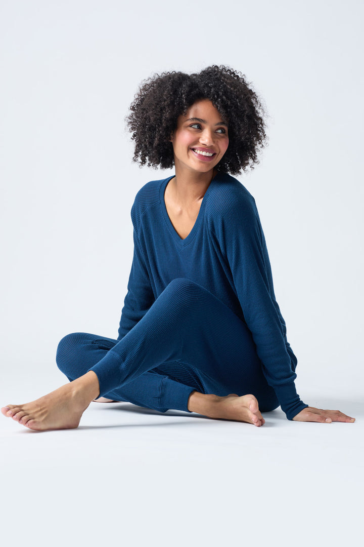 Navy V-neck top with relaxed fit in 2x2 peachy rib. Banded sleeve cuff & neck rib.
