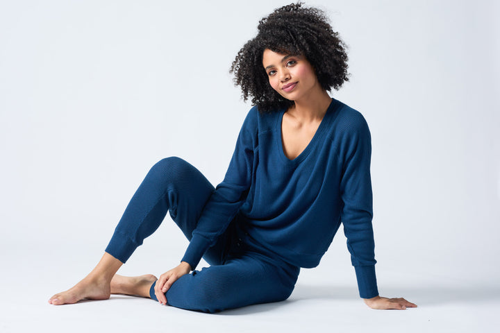 Navy V-neck top with relaxed fit in 2x2 peachy rib. Banded sleeve cuff & neck rib.
