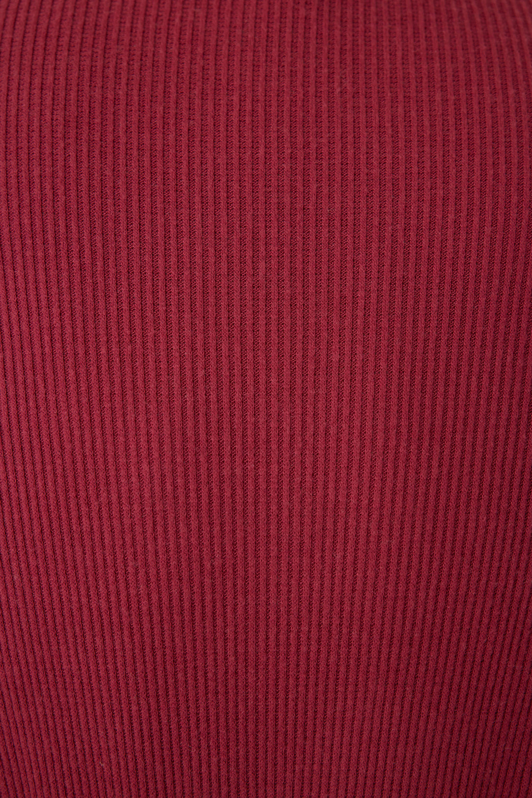 Close-up of the Textured Essentials Robe in Port by P.J. Salvage, featuring soft, stretchy ribbed fabric with vertical textured lines and a deep, muted red hue.