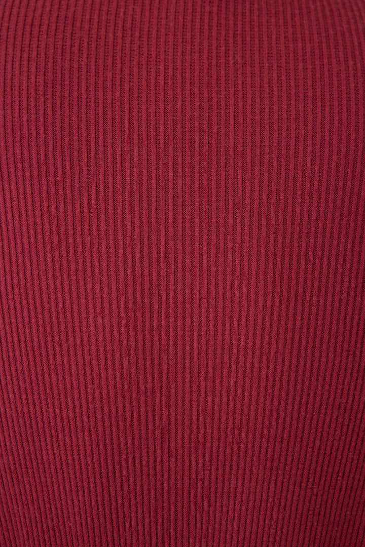 Close-up of the Textured Essentials Robe in Port by P.J. Salvage, featuring soft, stretchy ribbed fabric with vertical textured lines and a deep, muted red hue.