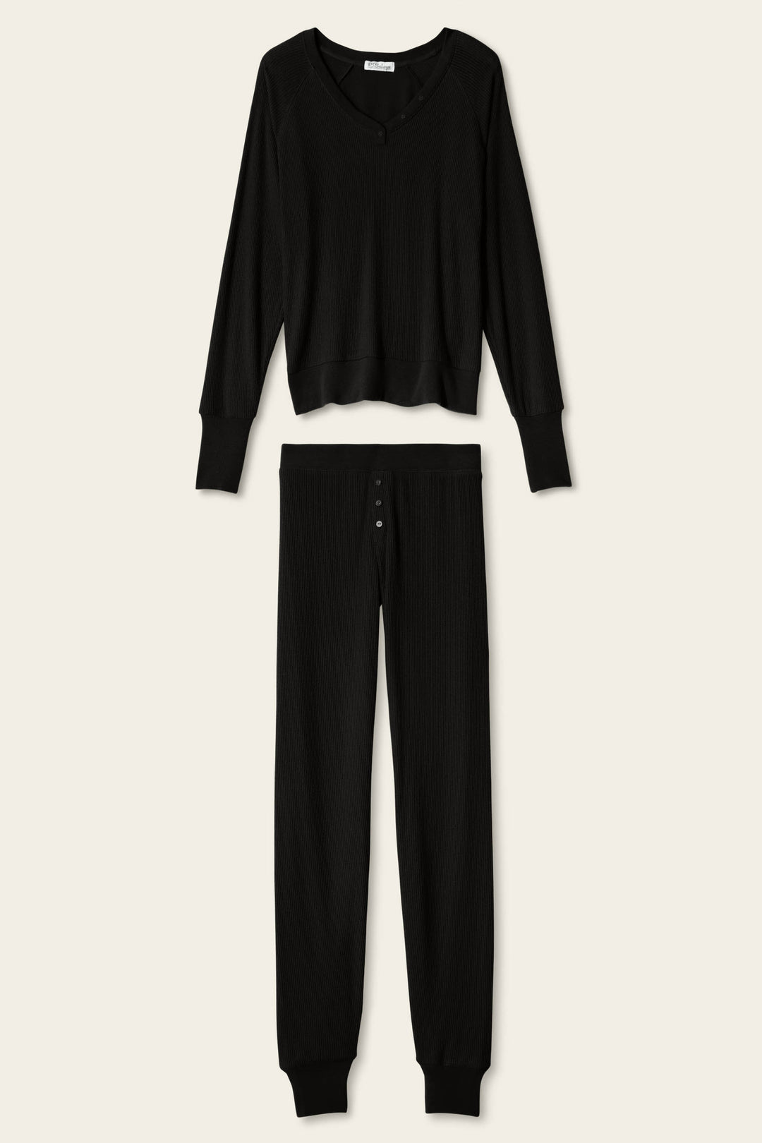The P.J. Salvage Textured Essentials Black Lounge Set features a matching ensemble of soft, ribbed fabric, including a relaxed V-neck long-sleeve top and button-fly pants, displayed on a plain light background.