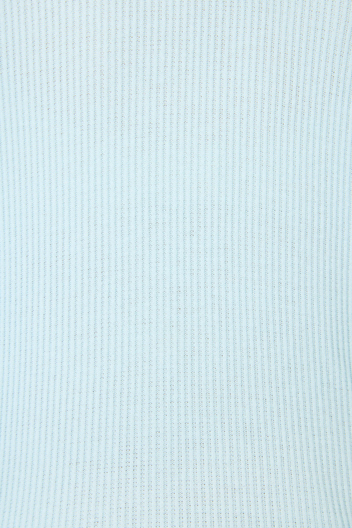 Close-up of P.J. Salvage's Textured Essentials Light Sky Pants Set, featuring a light blue ribbed fabric with vertical stripes. The soft, knitted material has a uniform pattern and a smooth, slightly stretchy surface.