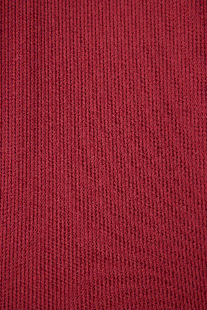 Close-up of the red ribbed fabric from P.J. Salvage’s Textured Essentials PJ Set, highlighting the vertical lines and detailed texture of the material.
