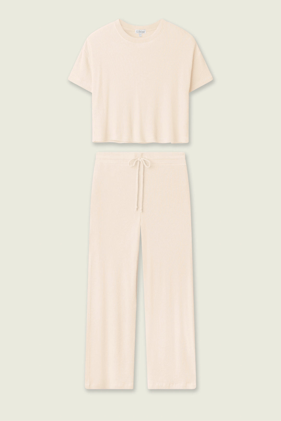 The P.J. Salvage Textured Essentials Stone Long PJ Set features a cream rib knit loungewear set with a short-sleeve cropped top and wide-leg, drawstring waist pants, shown against a plain light background.