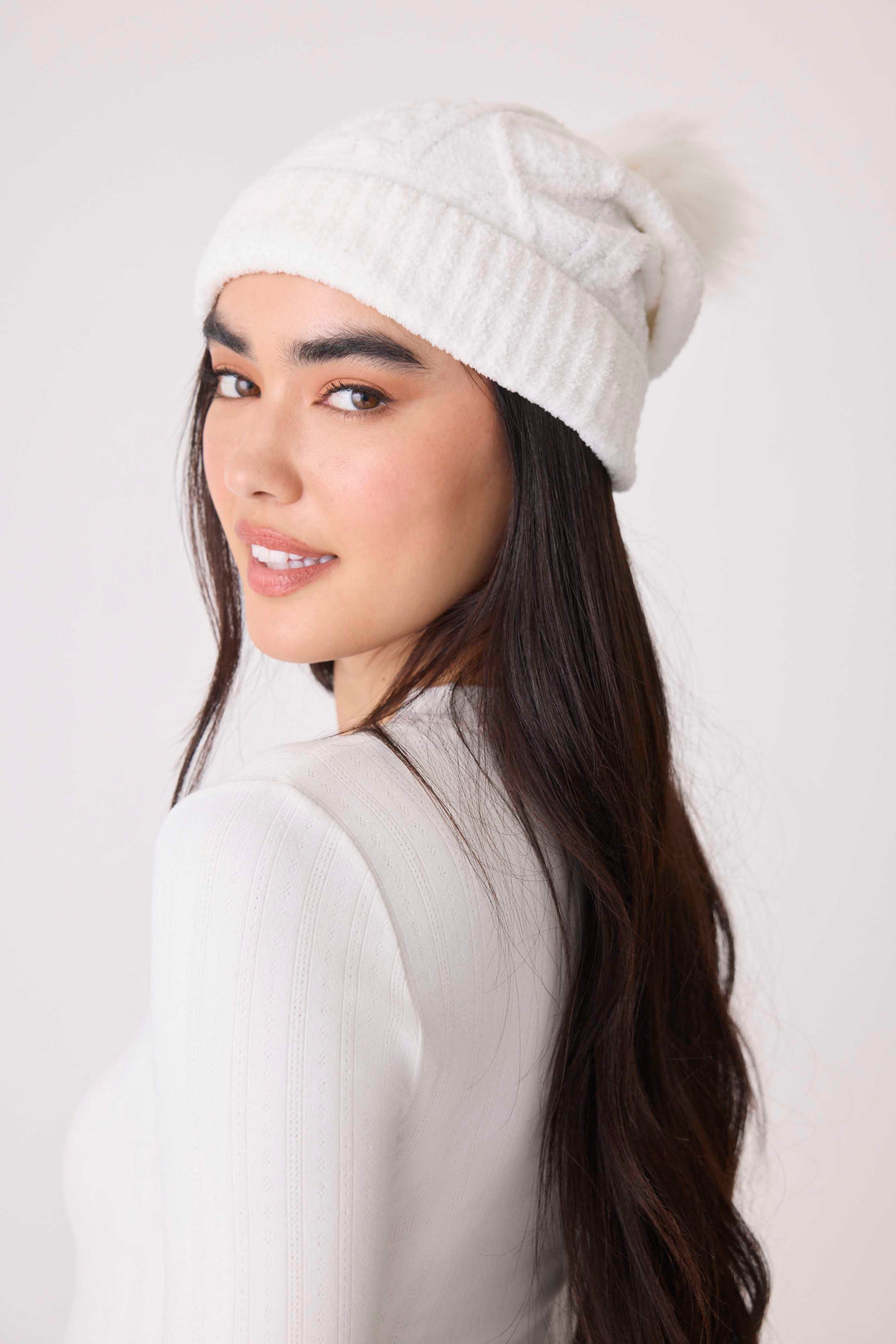 Women's cable texture knit beanie in ivory with pom pom on top.