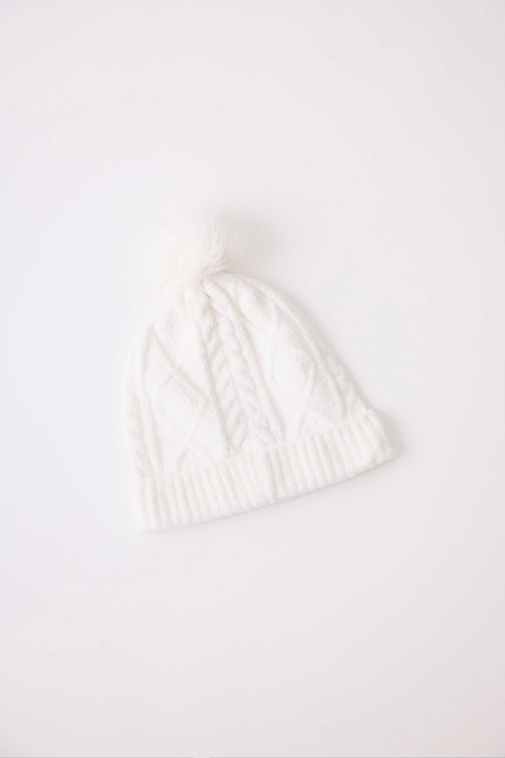 Women's cable texture knit beanie in ivory with pom pom on top.