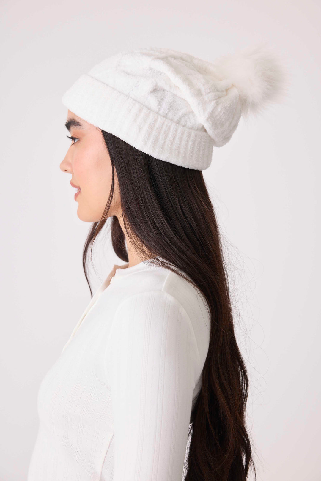 Women's cable texture knit beanie in ivory with pom pom on top.