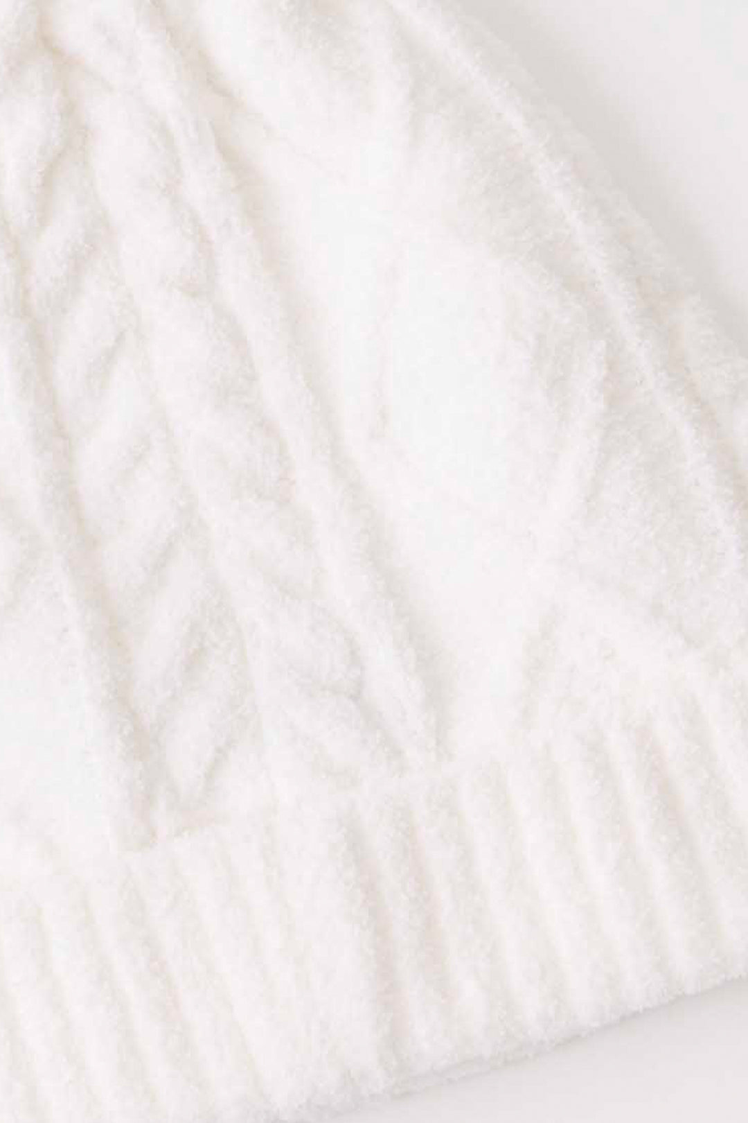 Women's cable texture knit beanie in ivory with pom pom on top.