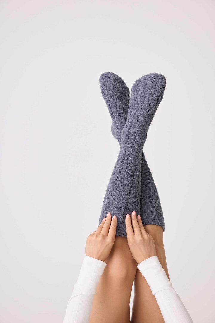 Women's cable texture cozy socks in charcoal grey. Non-skid grippers on soles.