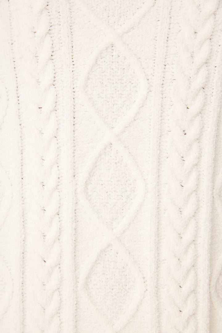 Close-up of the PJ SET CABLE CREW LOUNGE by P.J. Salvage, featuring a white knitted fabric with a textured cable and diamond pattern design.