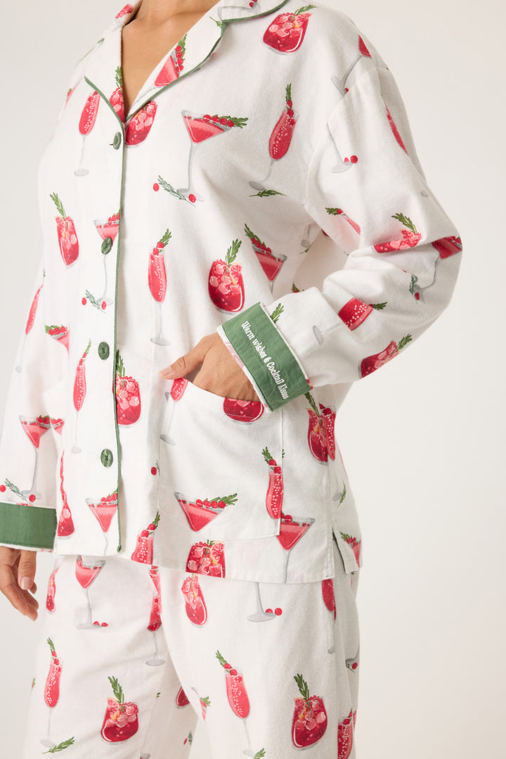 Women's cotton flannel pajama set in ivory & festive red cocktail print. Button-front collared top & tie-waist pant. Embroidered sleeve cuff "Warm Wishes & Cocktail Kisses". Includes matching hair wrap.