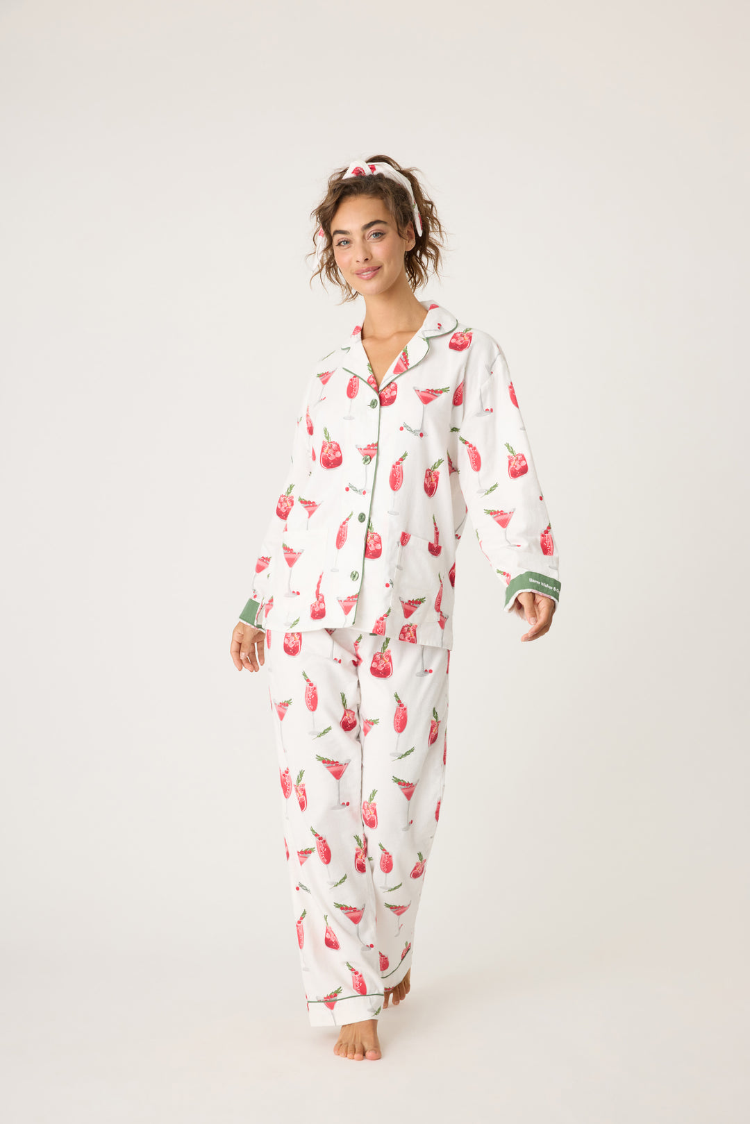 Women's cotton flannel pajama set in ivory & festive red cocktail print. Button-front collared top & tie-waist pant. Embroidered sleeve cuff "Warm Wishes & Cocktail Kisses". Includes matching hair wrap.