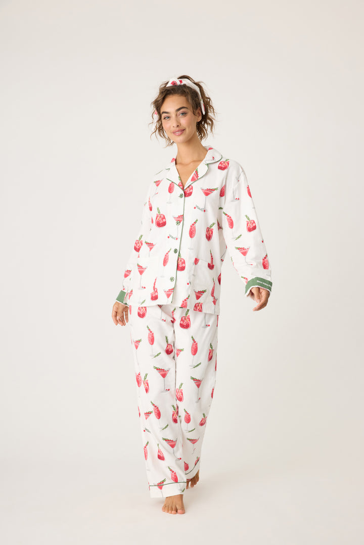 Women's cotton flannel pajama set in ivory & festive red cocktail print. Button-front collared top & tie-waist pant. Embroidered sleeve cuff "Warm Wishes & Cocktail Kisses". Includes matching hair wrap.