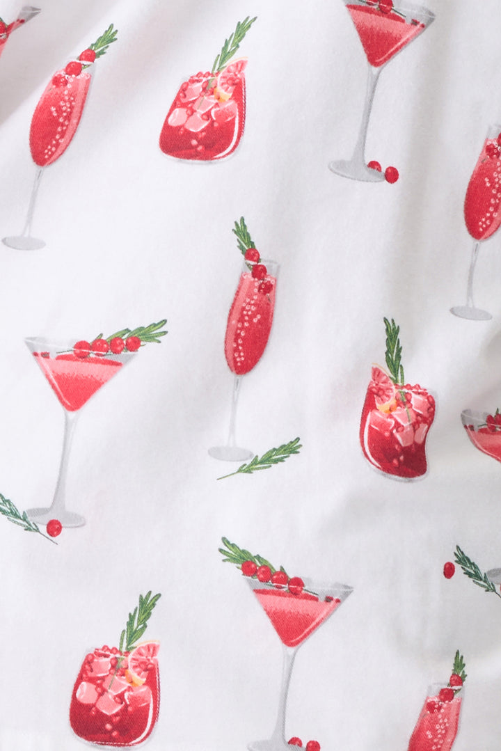 Women's cotton flannel pajama set in ivory & festive red cocktail print. Button-front collared top & tie-waist pant. Embroidered sleeve cuff "Warm Wishes & Cocktail Kisses". Includes matching hair wrap.
