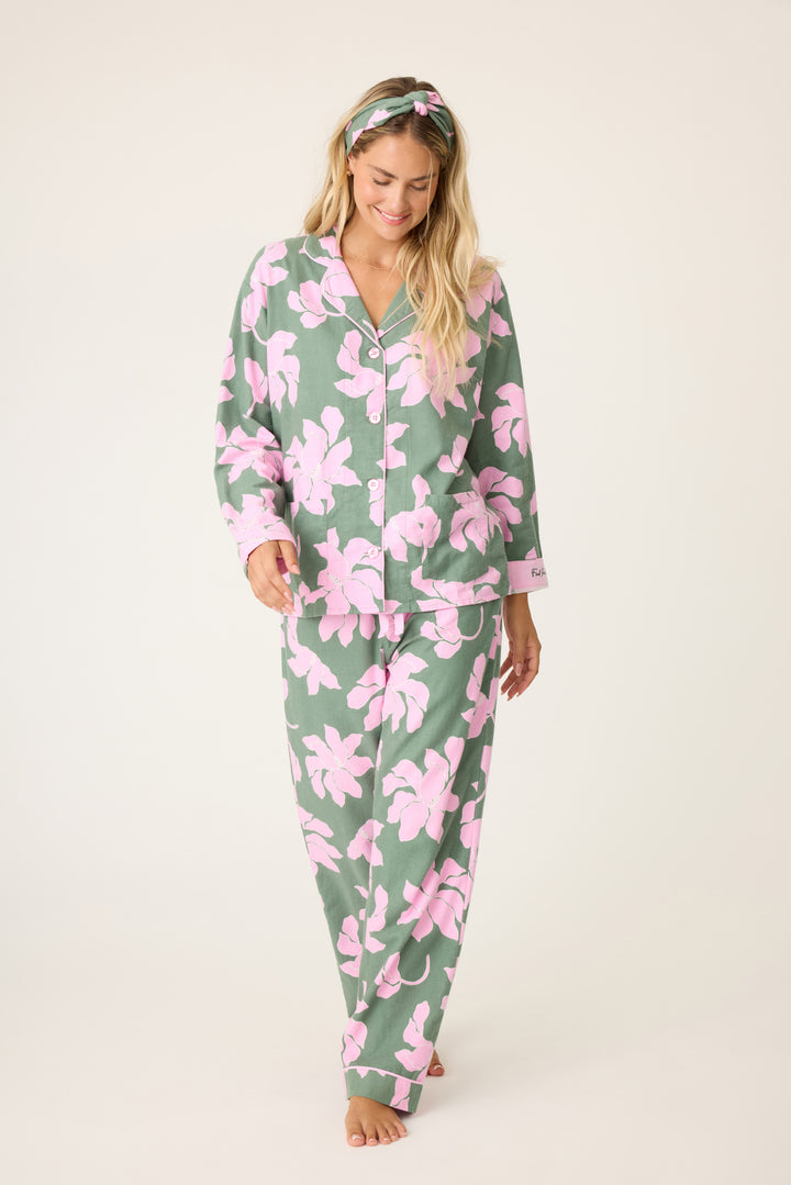 Women's cotton flannel pajama set in green & pink poinsettia print. Button-front collared top & tie-waist pant. Embroidered sleeve cuff "Find Peace Within". Includes matching hair wrap.
