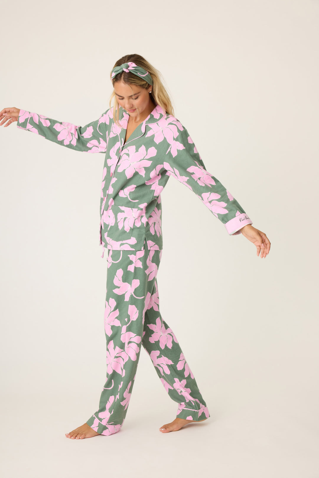 Women's cotton flannel pajama set in green & pink poinsettia print. Button-front collared top & tie-waist pant. Embroidered sleeve cuff "Find Peace Within". Includes matching hair wrap.