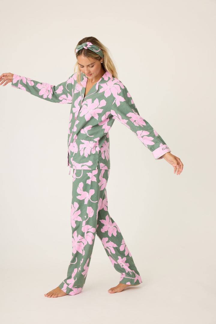 Women's cotton flannel pajama set in green & pink poinsettia print. Button-front collared top & tie-waist pant. Embroidered sleeve cuff "Find Peace Within". Includes matching hair wrap.