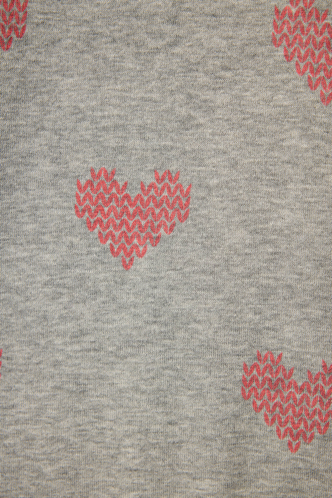 The Heart Print Fleece PJ Set by P.J. Salvage features gray fabric with evenly spaced, red pixelated heart motifs in a zigzag texture.