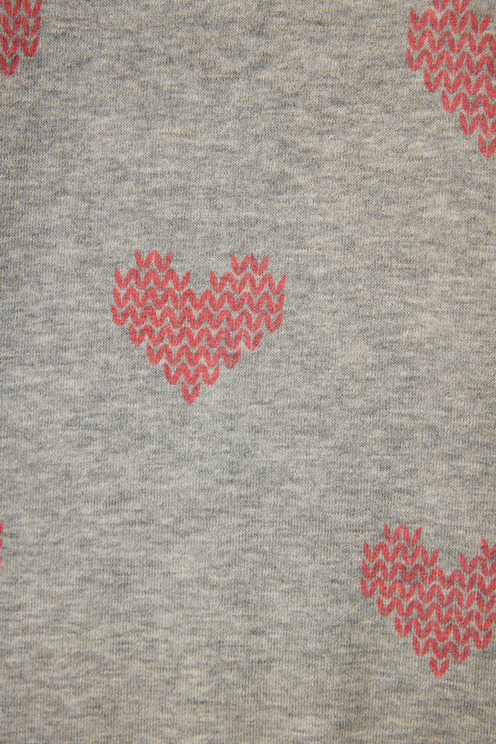 The Heart Print Fleece PJ Set by P.J. Salvage features gray fabric with evenly spaced, red pixelated heart motifs in a zigzag texture.