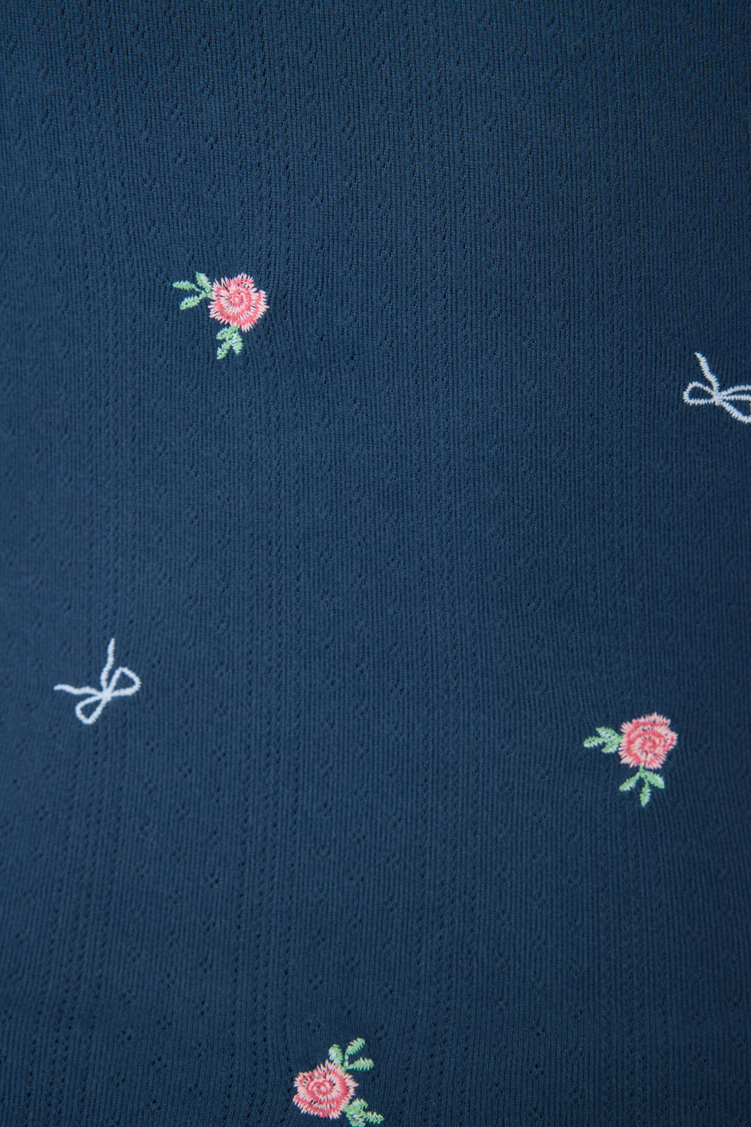 Navy blue floral camisole top for women with adjustable straps, picot edging, shelf bra, and curly hem.