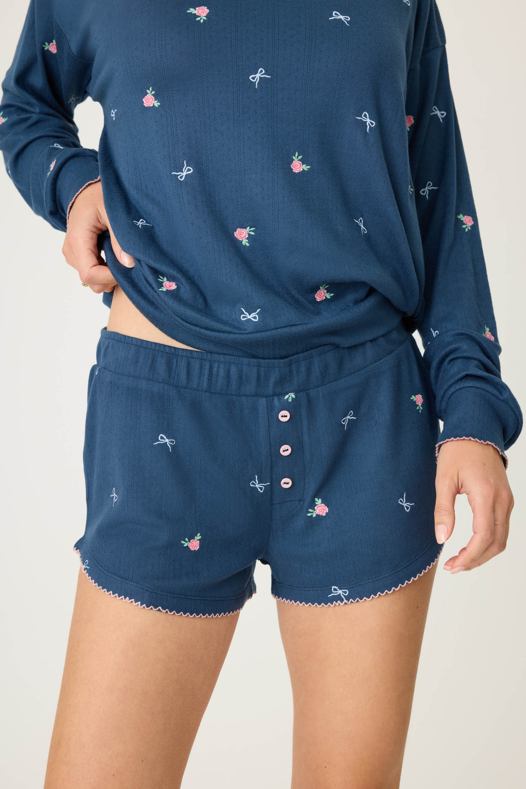 Navy blue with floral sleep short for women. Curved hem with picot edging.