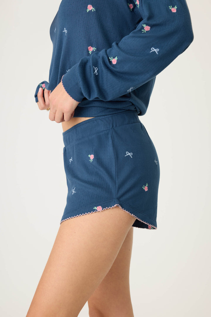 Navy blue with floral sleep short for women. Curved hem with picot edging.