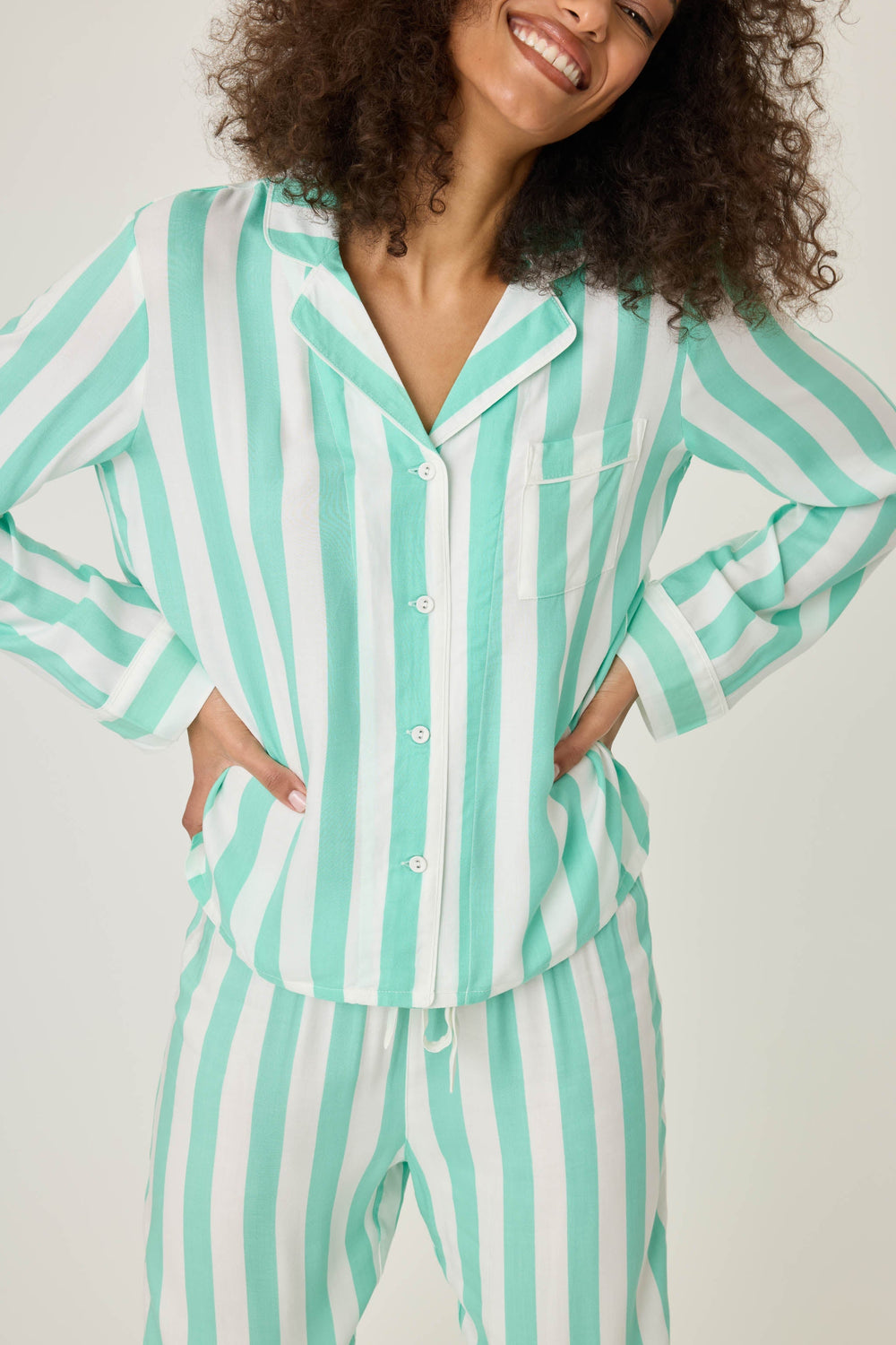Long sleeve women's pajama top in ivory-green stripes in woven rayon sateen. Button-front wtih chest pocket & contrast striped cuffs.