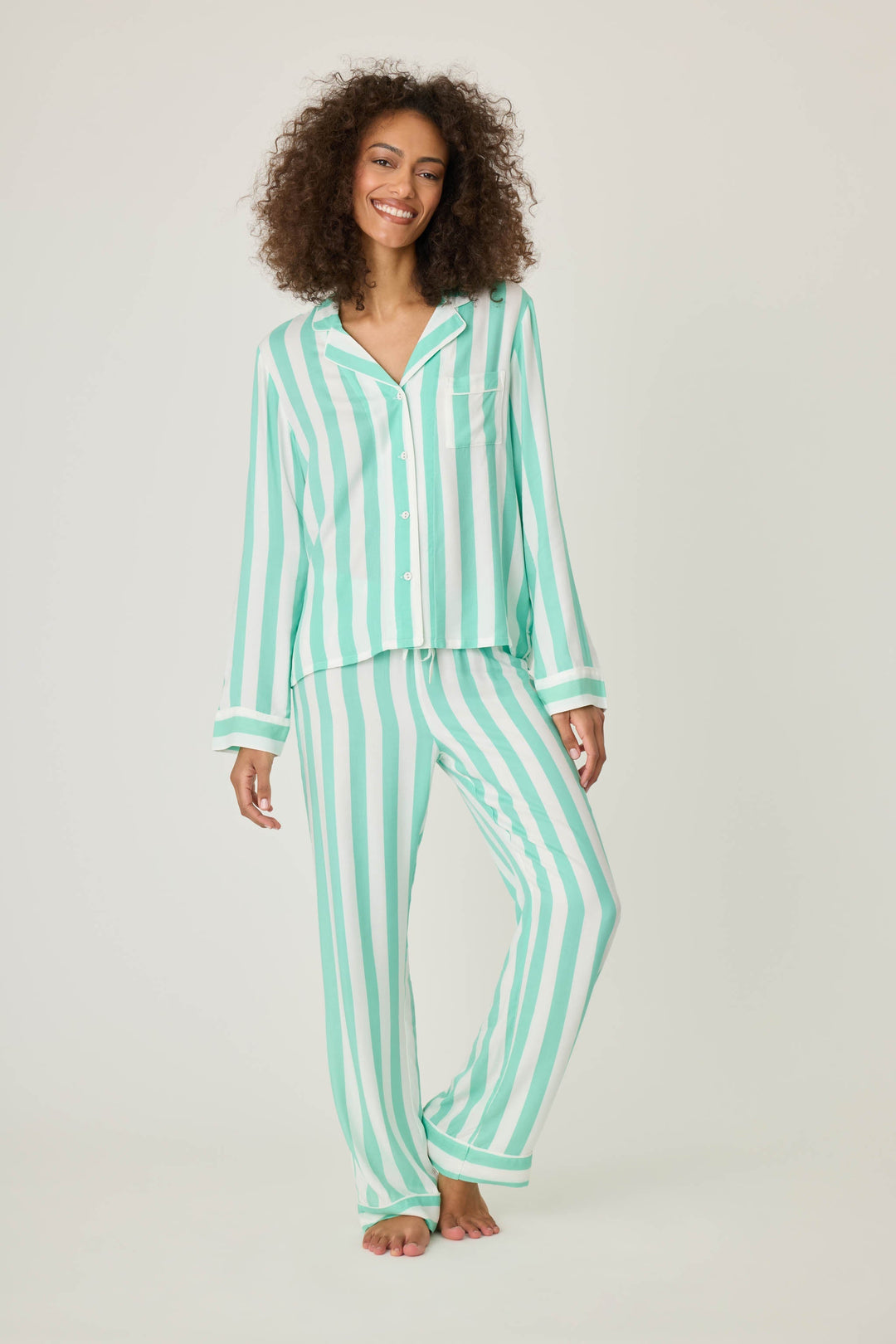 Long sleeve women's pajama top in ivory-green stripes in woven rayon sateen. Button-front wtih chest pocket & contrast striped cuffs.