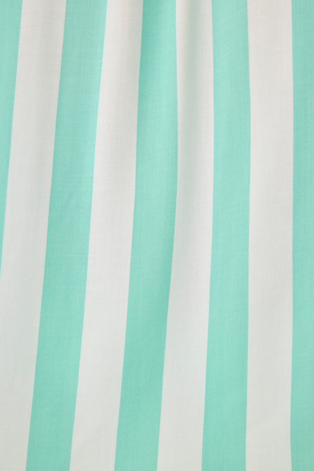 Long sleeve women's pajama top in ivory-green stripes in woven rayon sateen. Button-front wtih chest pocket & contrast striped cuffs.
