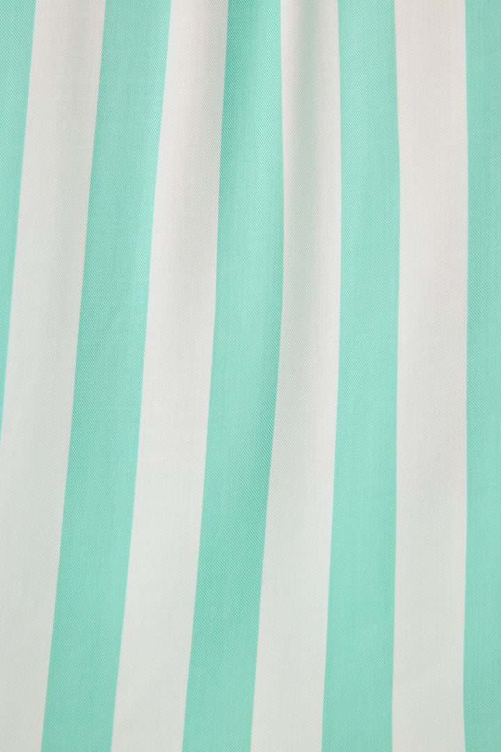 Long sleeve women's pajama top in ivory-green stripes in woven rayon sateen. Button-front wtih chest pocket & contrast striped cuffs.