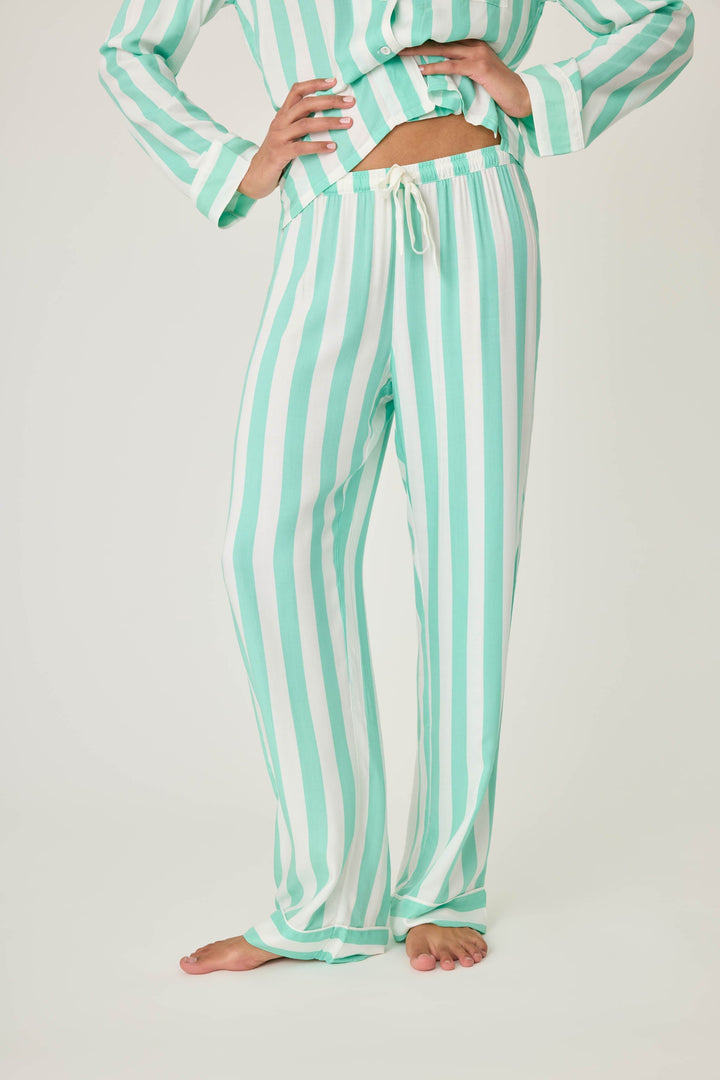 Women's pajama pant in ivory-green stripe print in woven rayon sateen. Tie-waist and contrast striped cuffs.