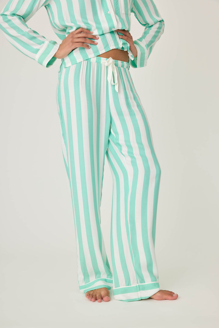 Women's pajama pant in ivory-green stripe print in woven rayon sateen. Tie-waist and contrast striped cuffs.