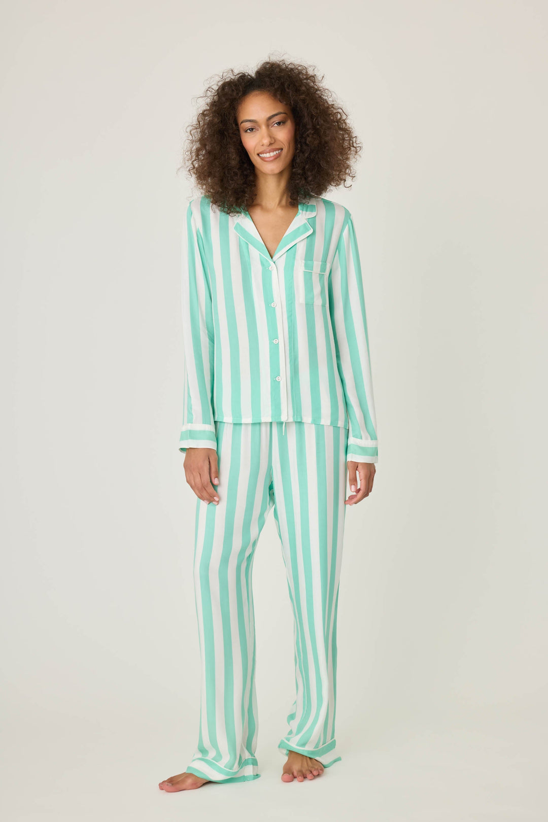 Women's pajama pant in ivory-green stripe print in woven rayon sateen. Tie-waist and contrast striped cuffs.