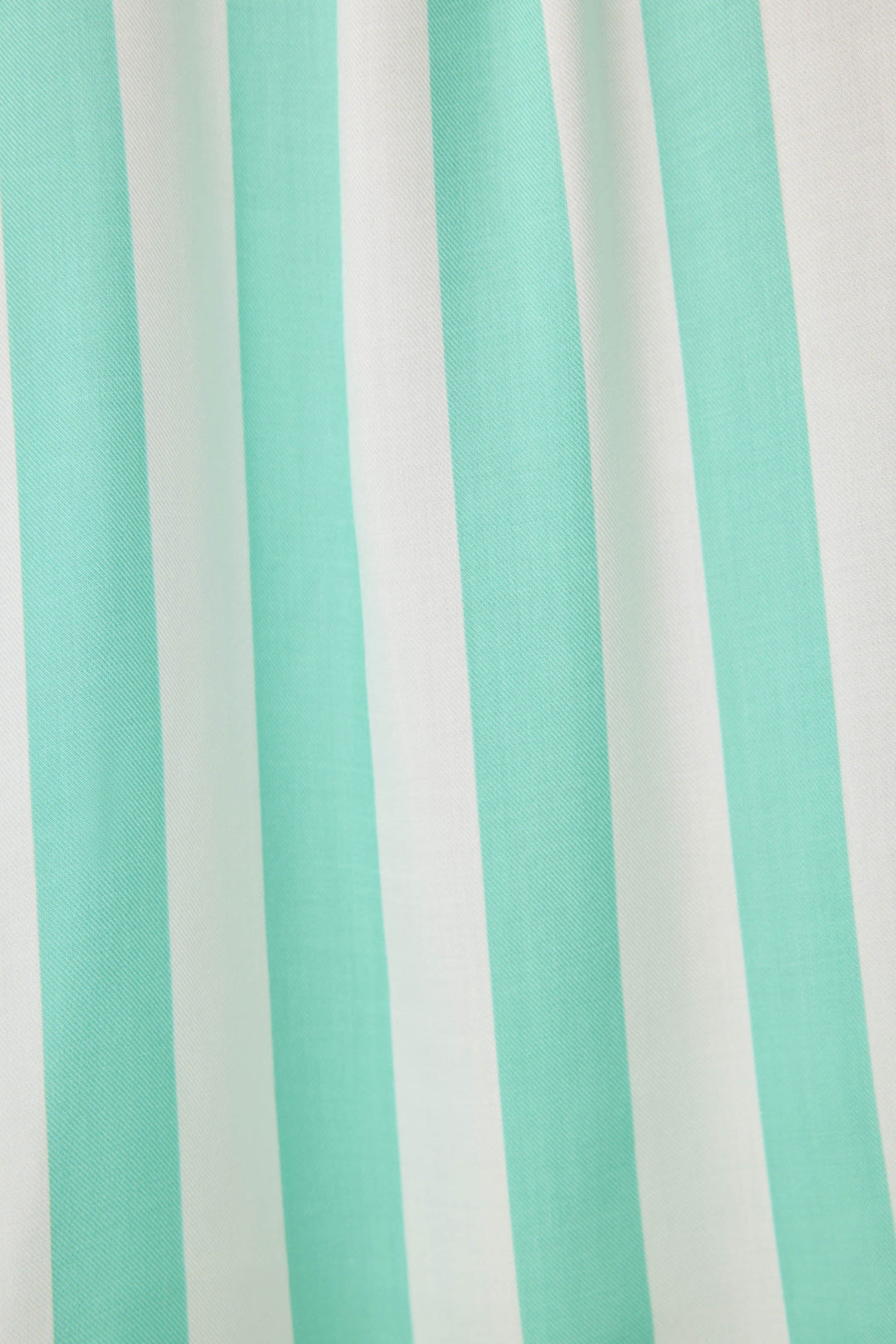 Women's pajama pant in ivory-green stripe print in woven rayon sateen. Tie-waist and contrast striped cuffs.