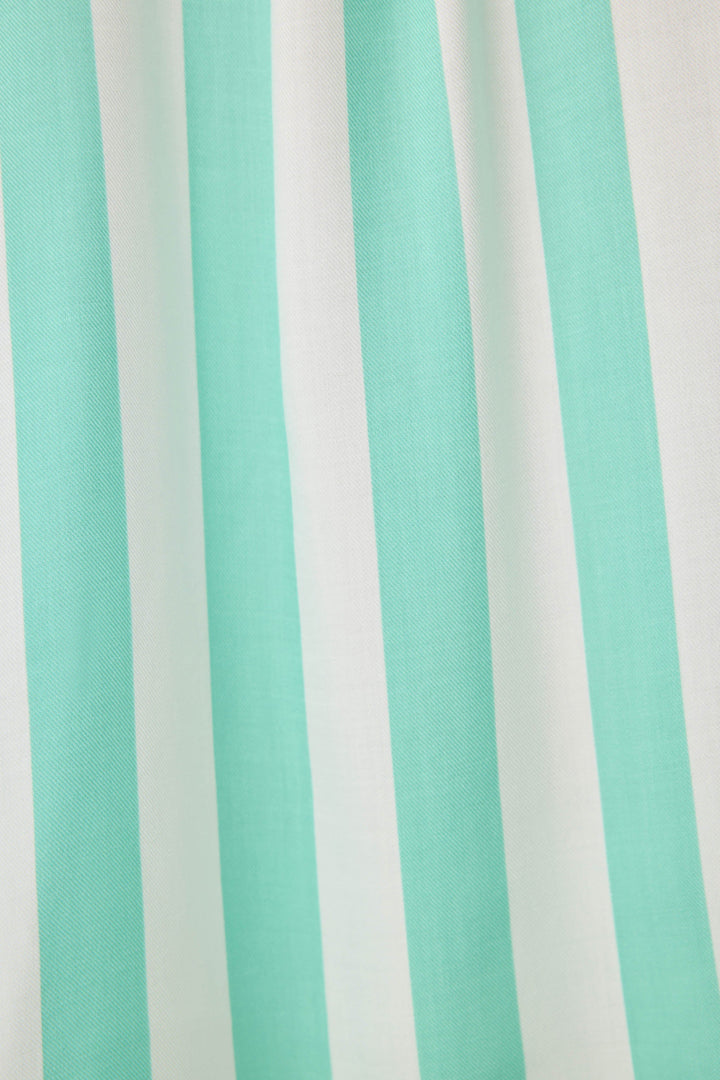 Women's pajama pant in ivory-green stripe print in woven rayon sateen. Tie-waist and contrast striped cuffs.