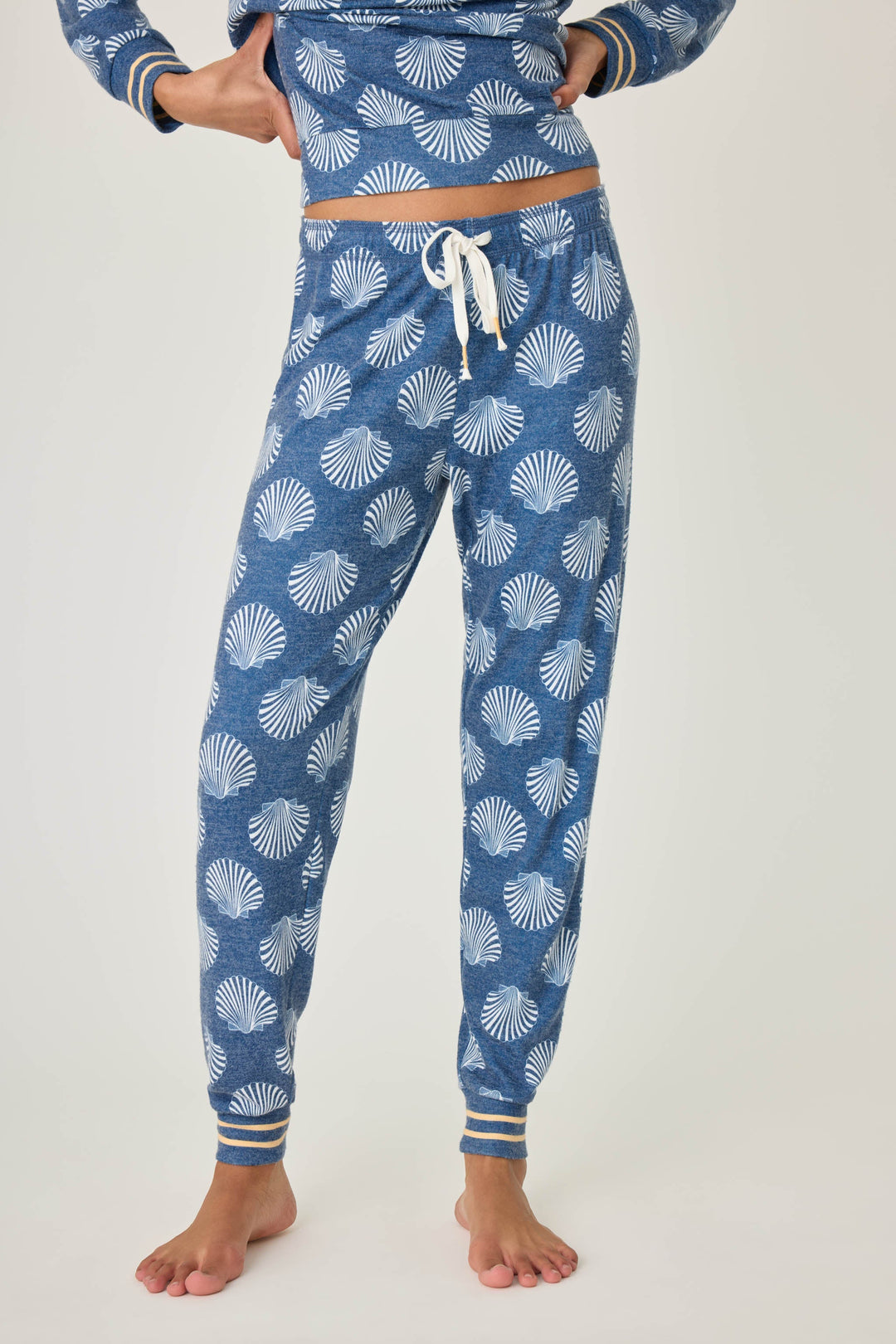 Navy shell-printed jogger pant for women. Tie waist with gold striped ankle cuffs.