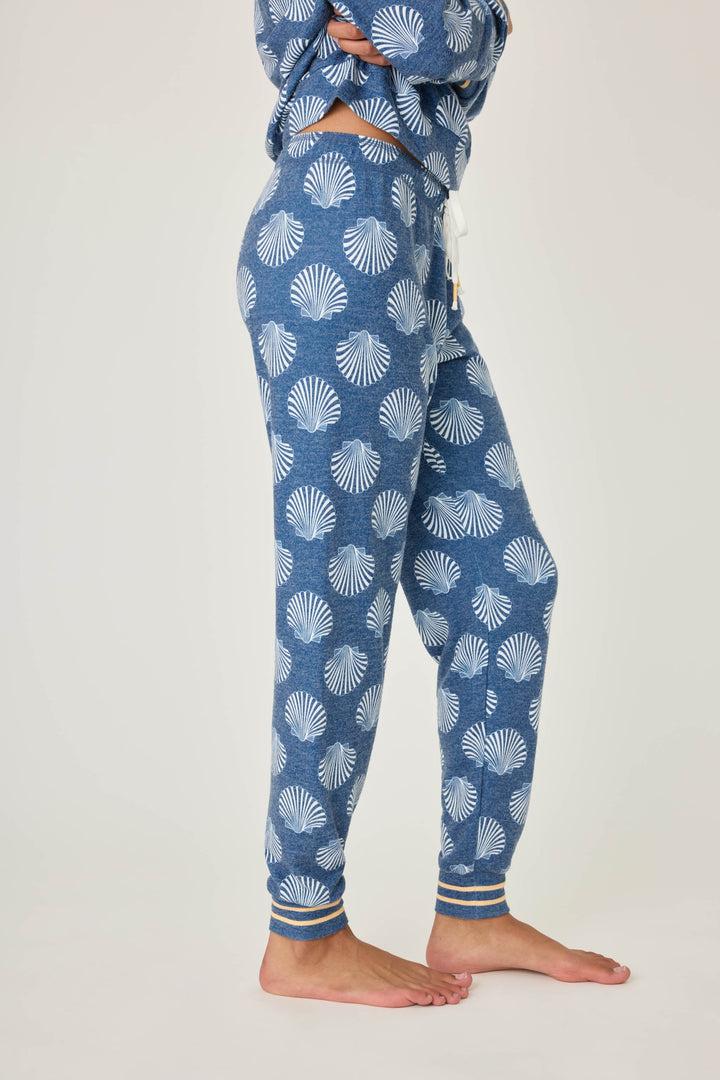 Navy shell-printed jogger pant for women. Tie waist with gold striped ankle cuffs.