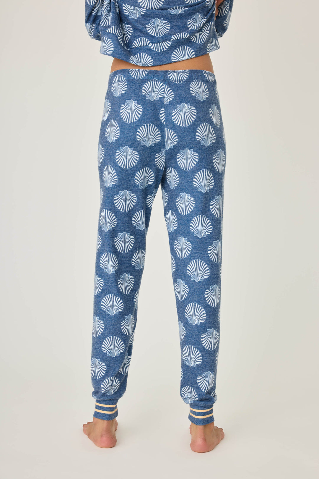 Navy shell-printed jogger pant for women. Tie waist with gold striped ankle cuffs.