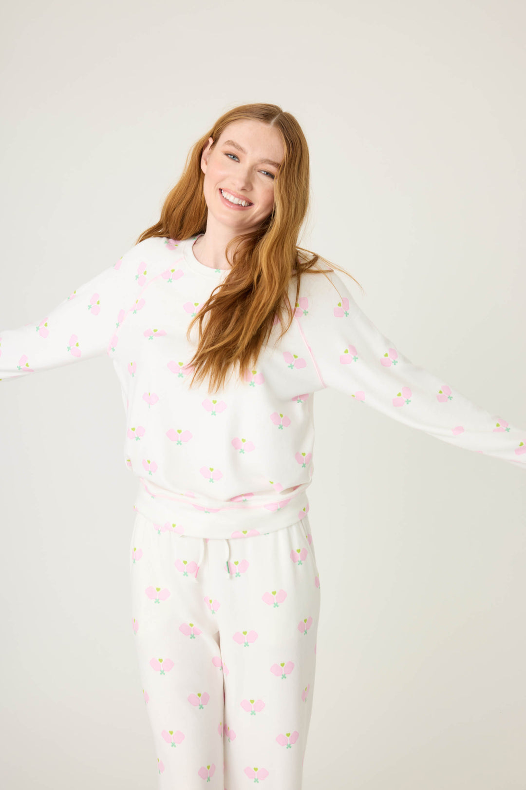 Pickleball racket-printed lounge top for women in ivory-pink. Raglan sleeves & banded hem.