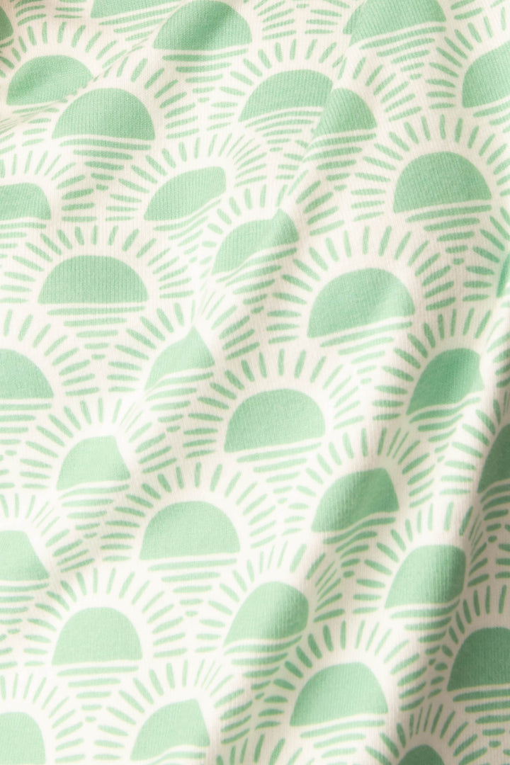 Women's spring racket-sun printed lounge top in ivory-green pattern, with striped pink cuffs.