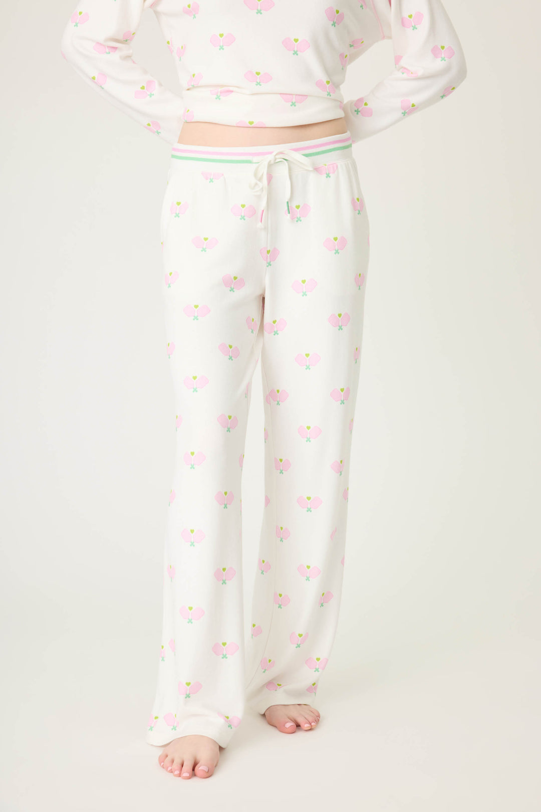 Pickleball racket-printed lounge pant for women in ivory-pink. Side pockets & striped waistband.