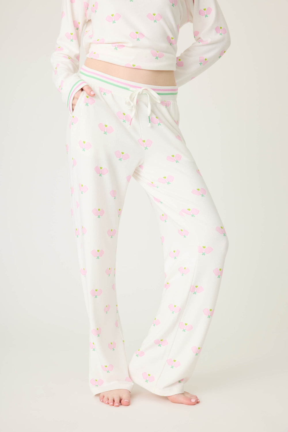 Pickleball racket-printed lounge pant for women in ivory-pink. Side pockets & striped waistband.