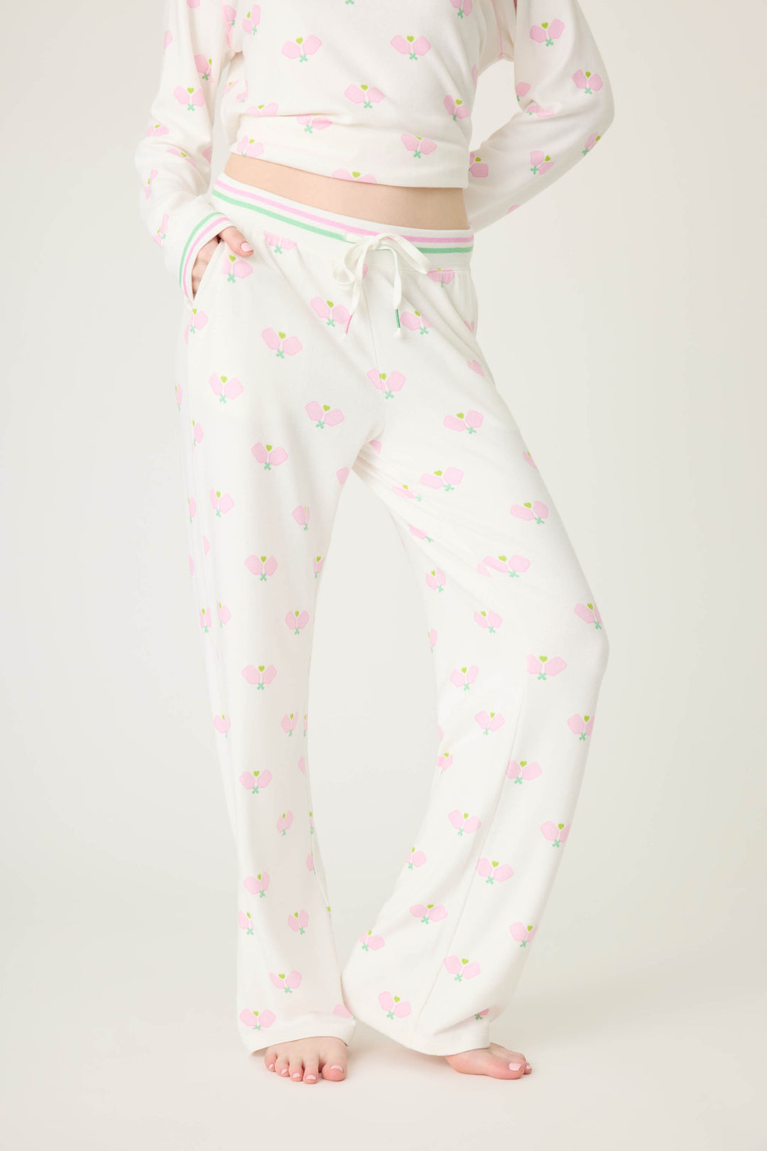 Pickleball racket-printed lounge pant for women in ivory-pink. Side pockets & striped waistband.
