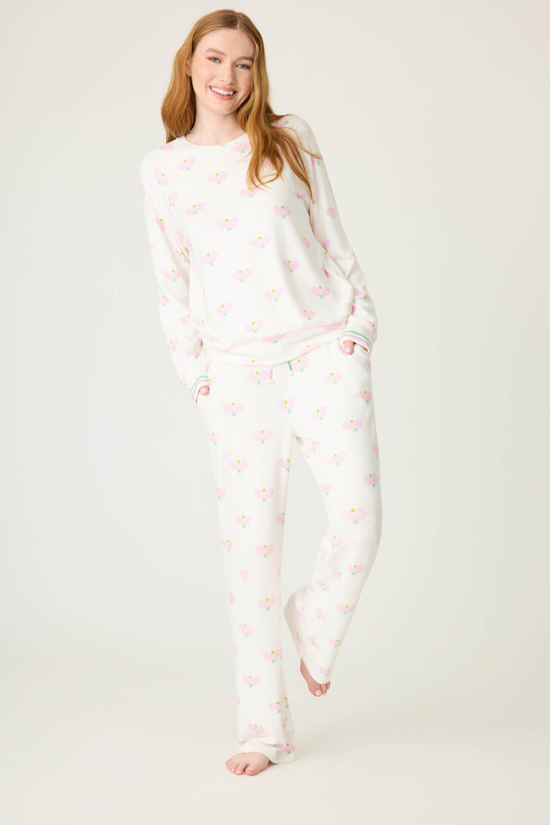 Pickleball racket-printed lounge pant for women in ivory-pink. Side pockets & striped waistband.