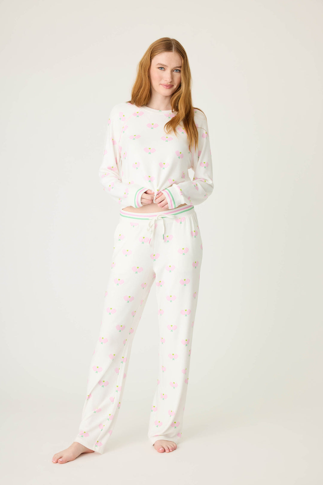 Pickleball racket-printed lounge pant for women in ivory-pink. Side pockets & striped waistband.